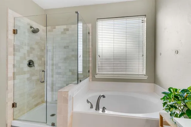 a bathroom with a bathtub and shower