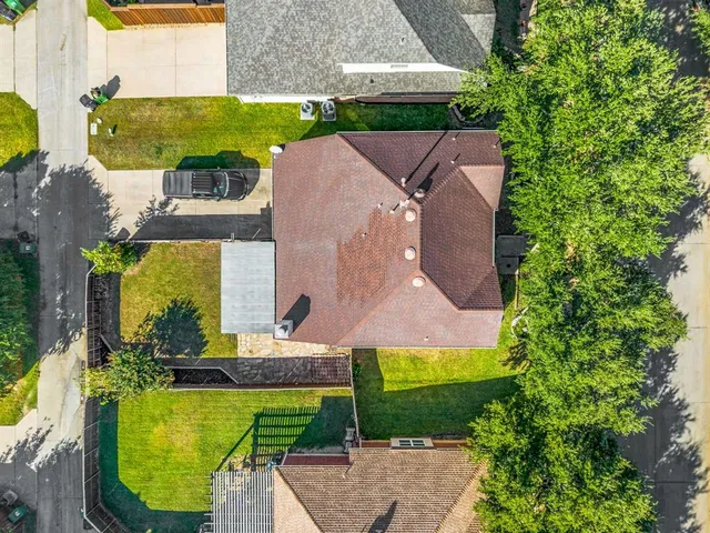 an aerial view of a house with a garden and swimming pool