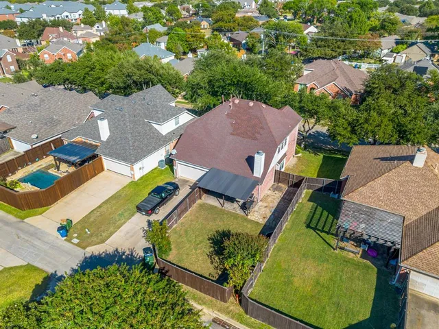 an aerial view of residential houses with outdoor space and swimming pool