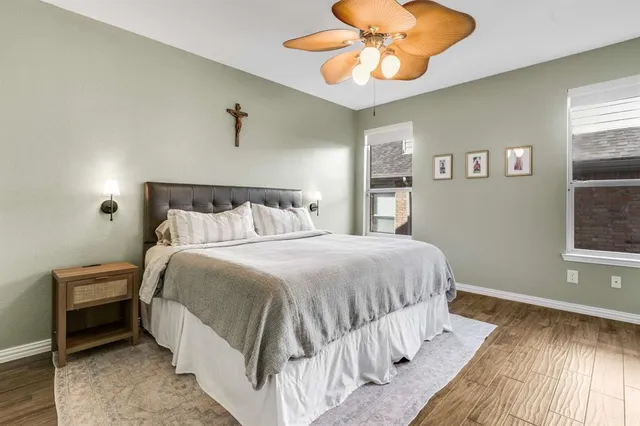 a bedroom with a bed and a chandelier