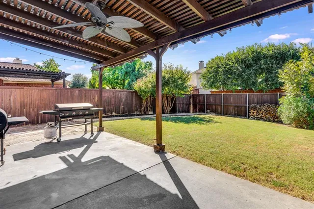 a swimming pool with a outdoor seating and yard
