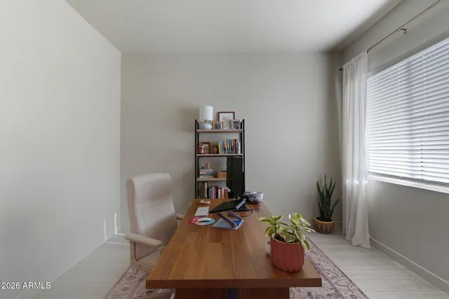 a view of a room with gym equipment and windows