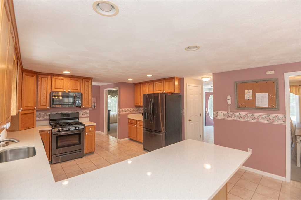 3 Maria Drive Ipswich, MA 01938 - Photo 11 of 36 a kitchen with stainless steel appliances a refrigerator and a stove top oven