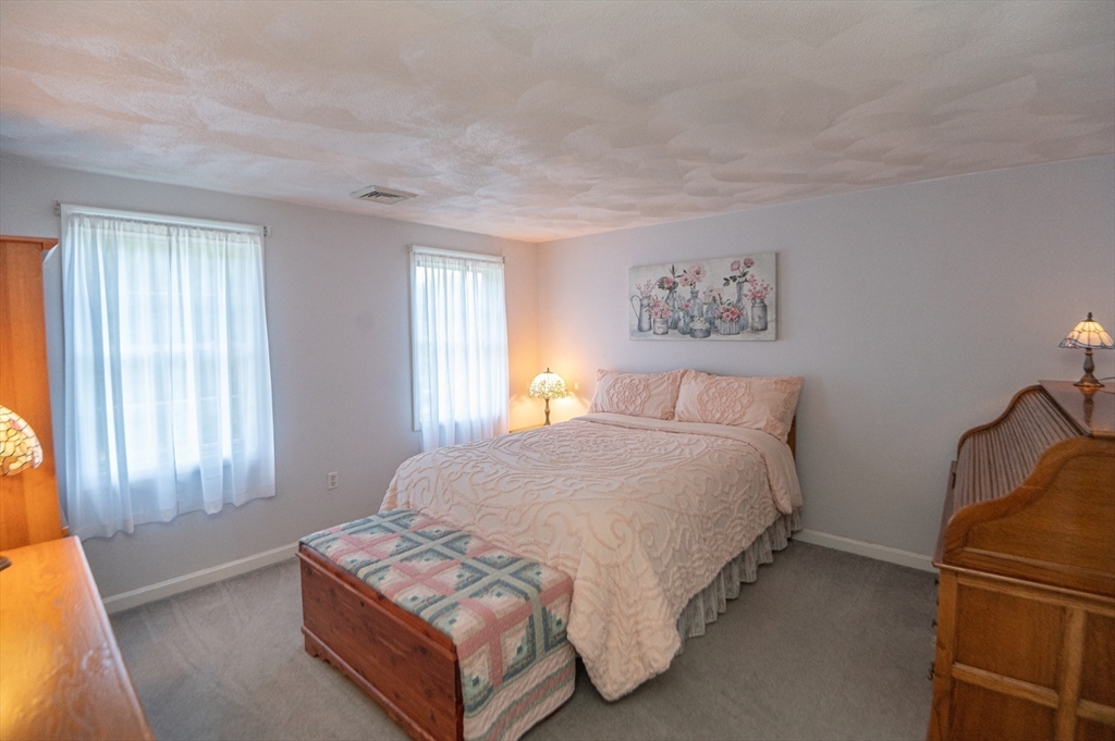 3 Maria Drive Ipswich, MA 01938 - Photo 23 of 36 a spacious bedroom with a bed and window