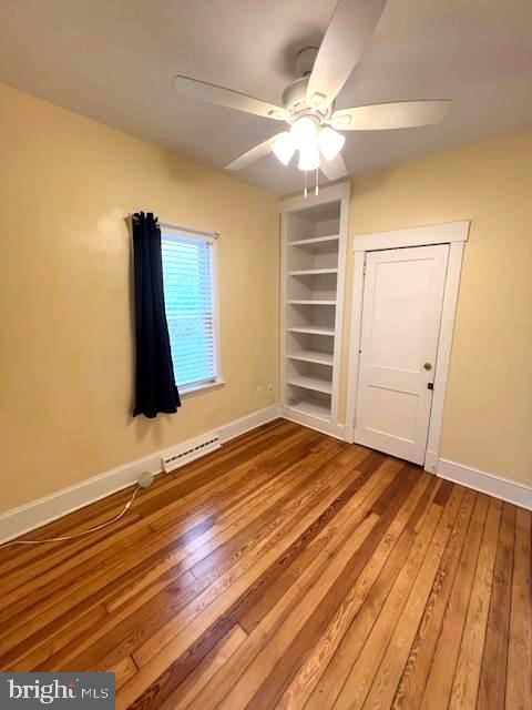 551 Washington Avenue Ewing, NJ 08628 - Photo 11 of 35 wooden floor in an empty room with a window