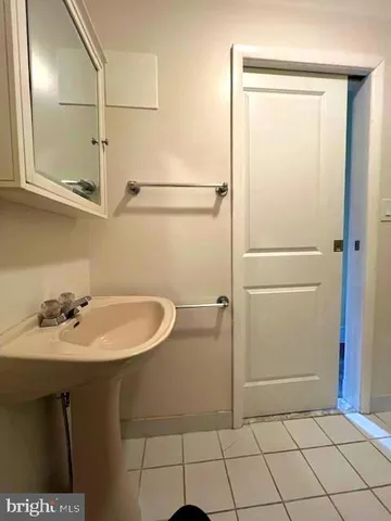 a bathroom with a glass shower door
