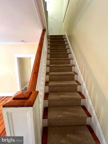 a view of empty room with window and ceiling fan