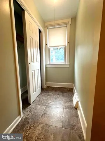 a view of a yard with car parked on road