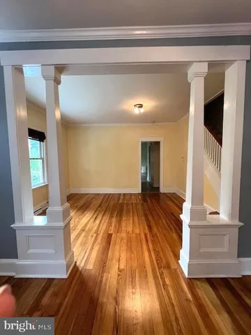 a view of a room with wooden floor and staircase
