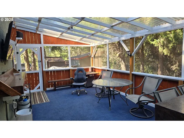 a backyard of a house with table and chairs