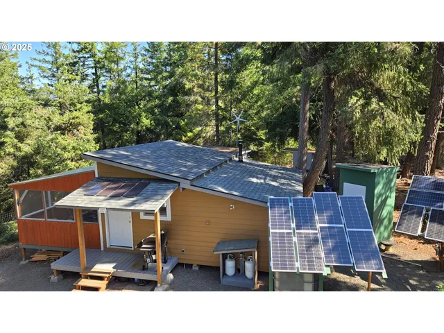 a black and white house with a yard