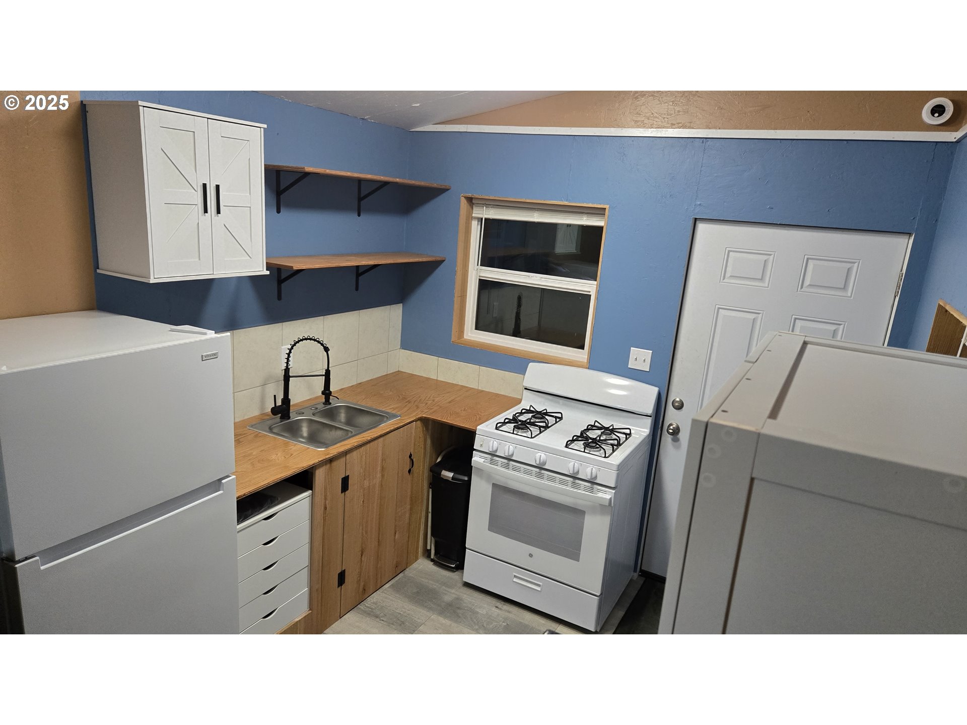 Pine Ridge, Unit 54 Goldendale, WA 98620 - Photo 5 of 43 a kitchen with a stove a sink and a microwave