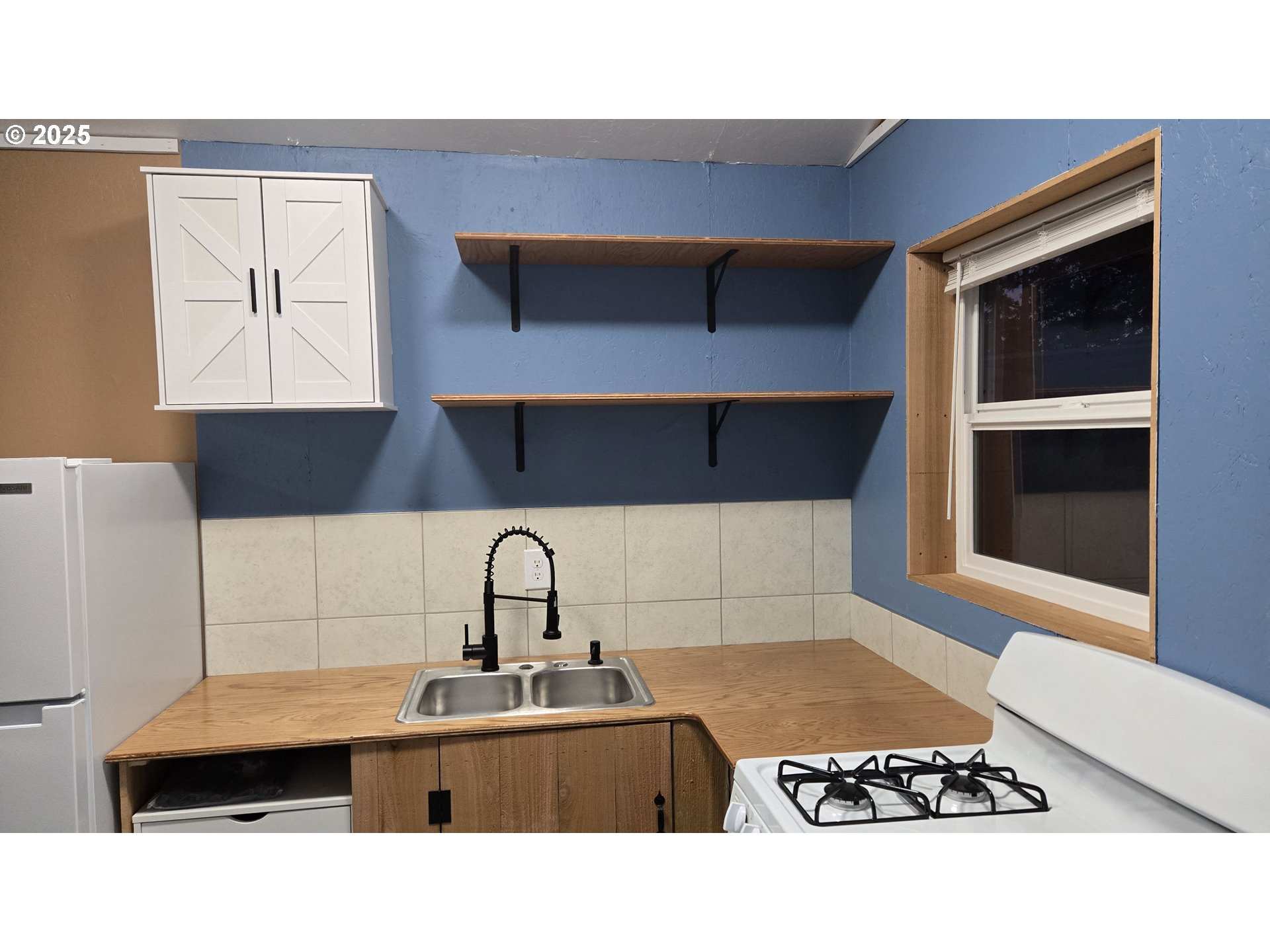 Pine Ridge, Unit 54 Goldendale, WA 98620 - Photo 6 of 43 a kitchen with a sink a stove and cabinets