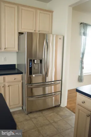 a kitchen with a refrigerator and cabinets