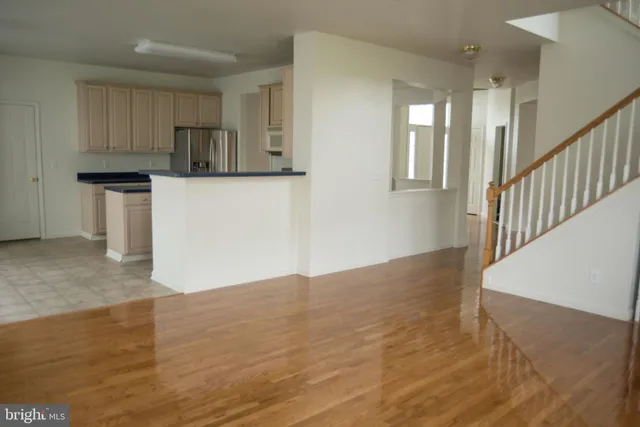 a view of a kitchen with wooden floor and electronic appliances
