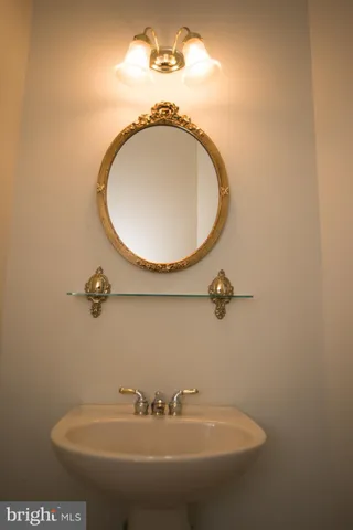 a bathroom with a sink and mirror