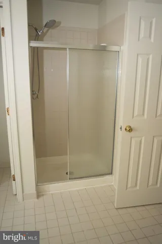 a bathroom with a glass door shower