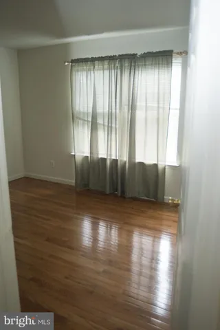 a view of wooden floor and windows in a room