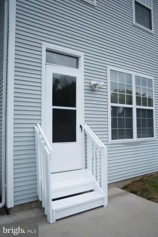 a view of a house with white door and a window