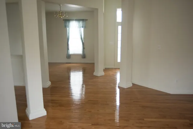 a view of hallway with wooden floor