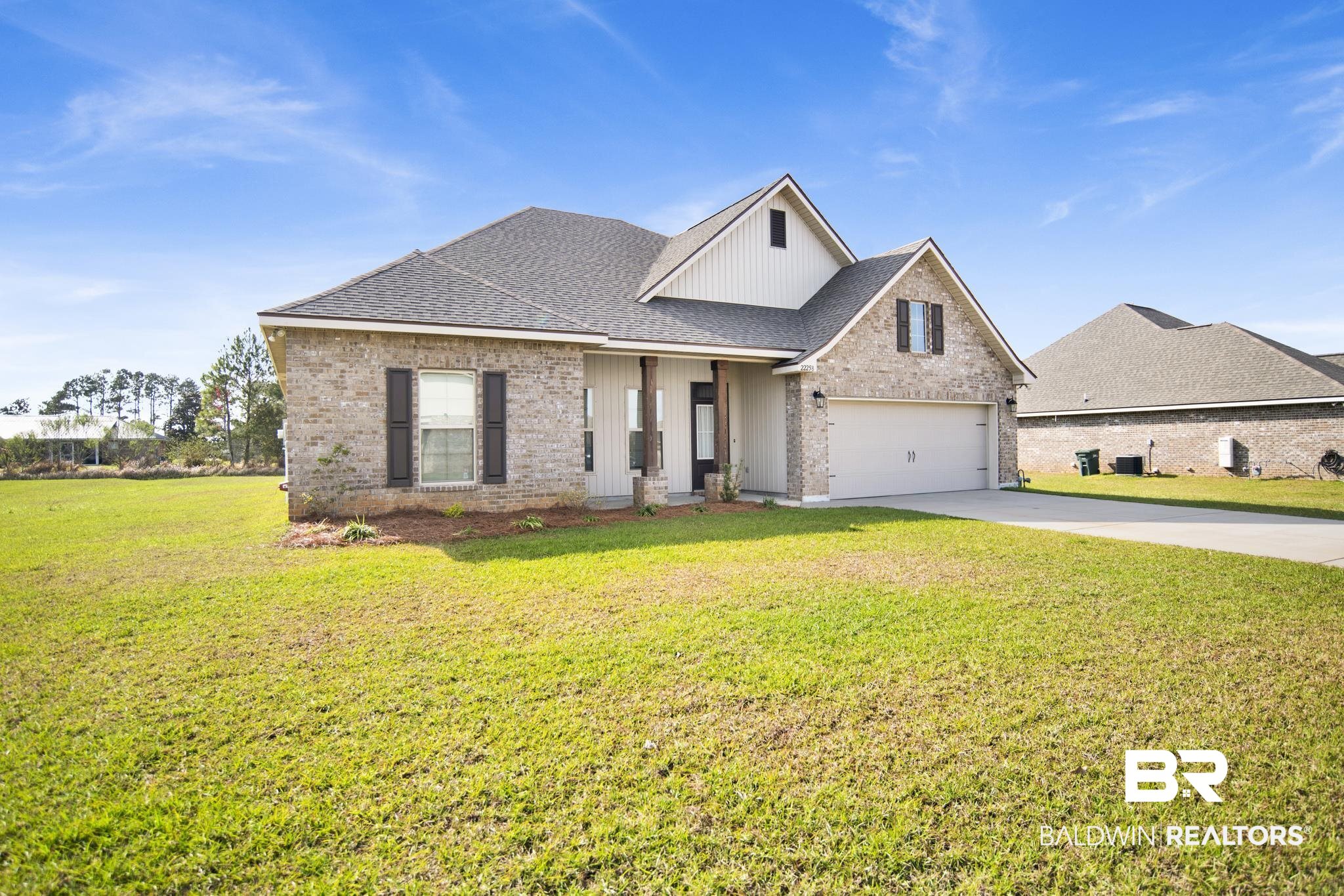 22258 Hibiscus Circle Foley, AL 36535 - Photo 3 of 26 View of front facade featuring brick siding, concrete driveway, a front yard, and a shingled roof