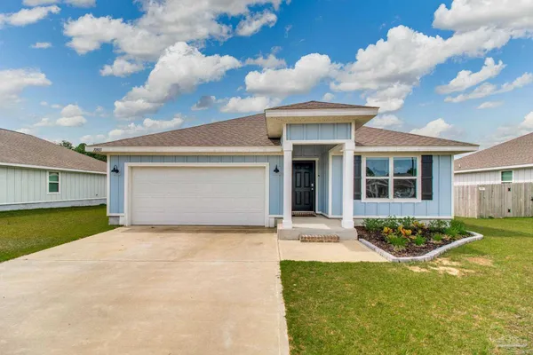 a view of a house with backyard and sitting area