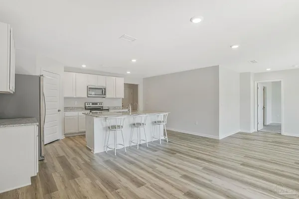 a bedroom with a bed a couch and a window