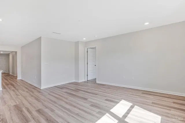 a view of roof deck with couches and wooden fence