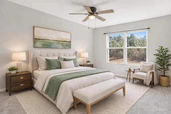 a bedroom with a bed and a large window