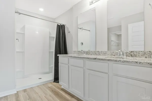a view of roof deck with couches and wooden fence