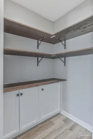 a large kitchen with stainless steel appliances a large counter top a stove and a refrigerator