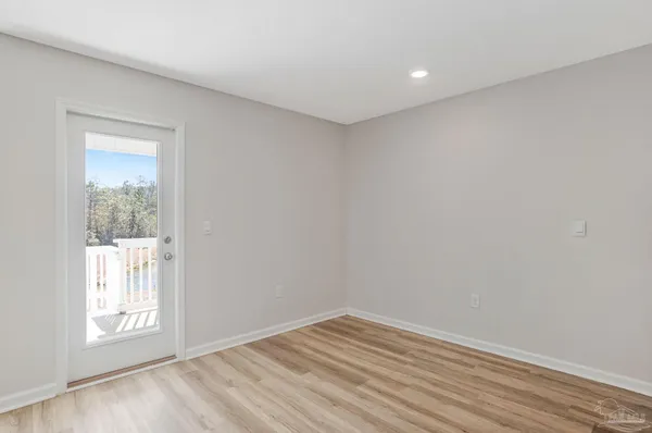 a living room with furniture a flat screen tv and a window