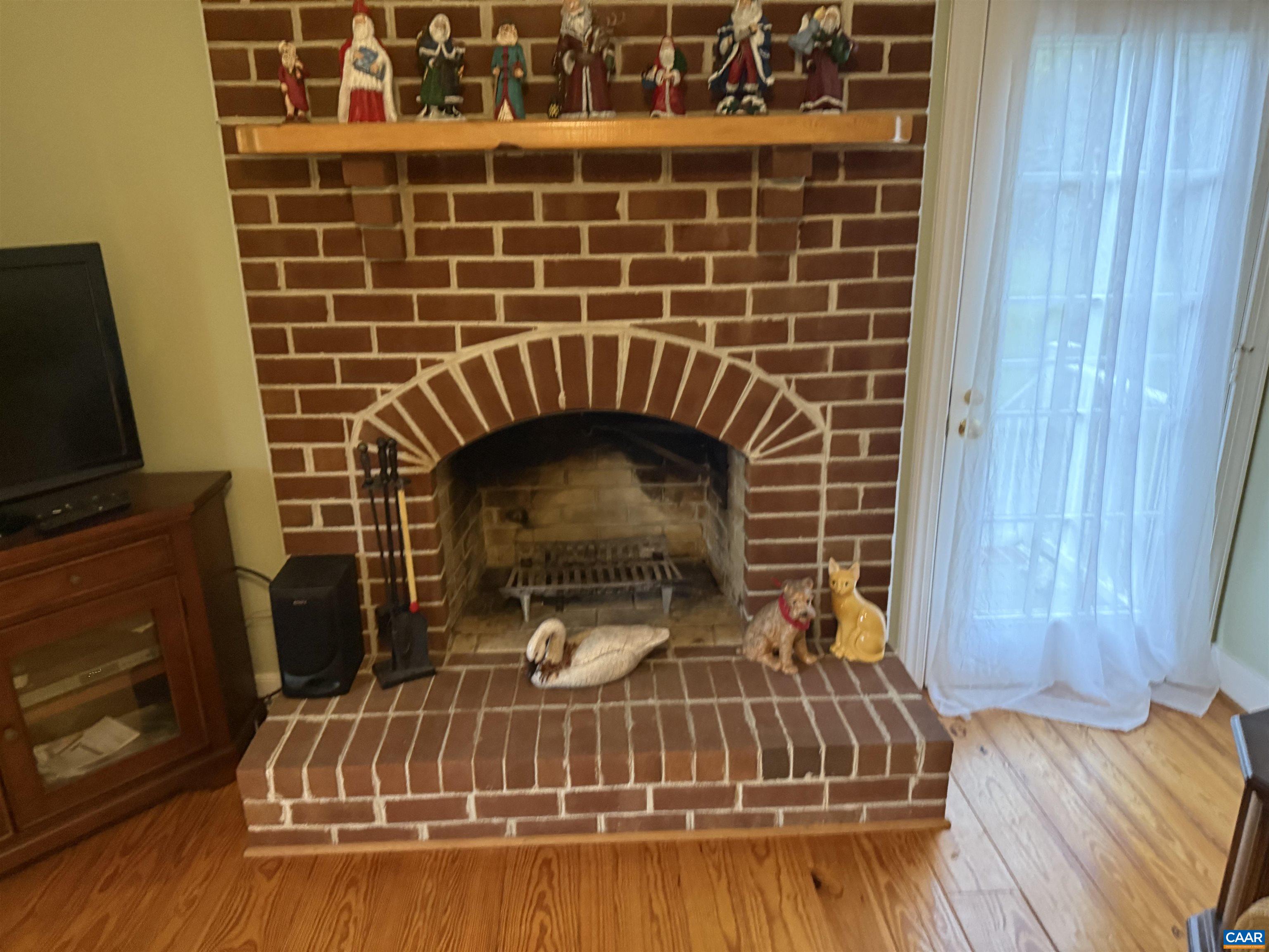 5051 Shannon Hill Road Kents Store, VA 23084 - Photo 11 of 67 a view of a fireplace with wooden floor