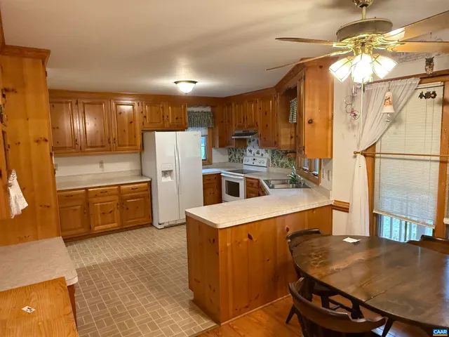 a kitchen with sink a window and cabinets