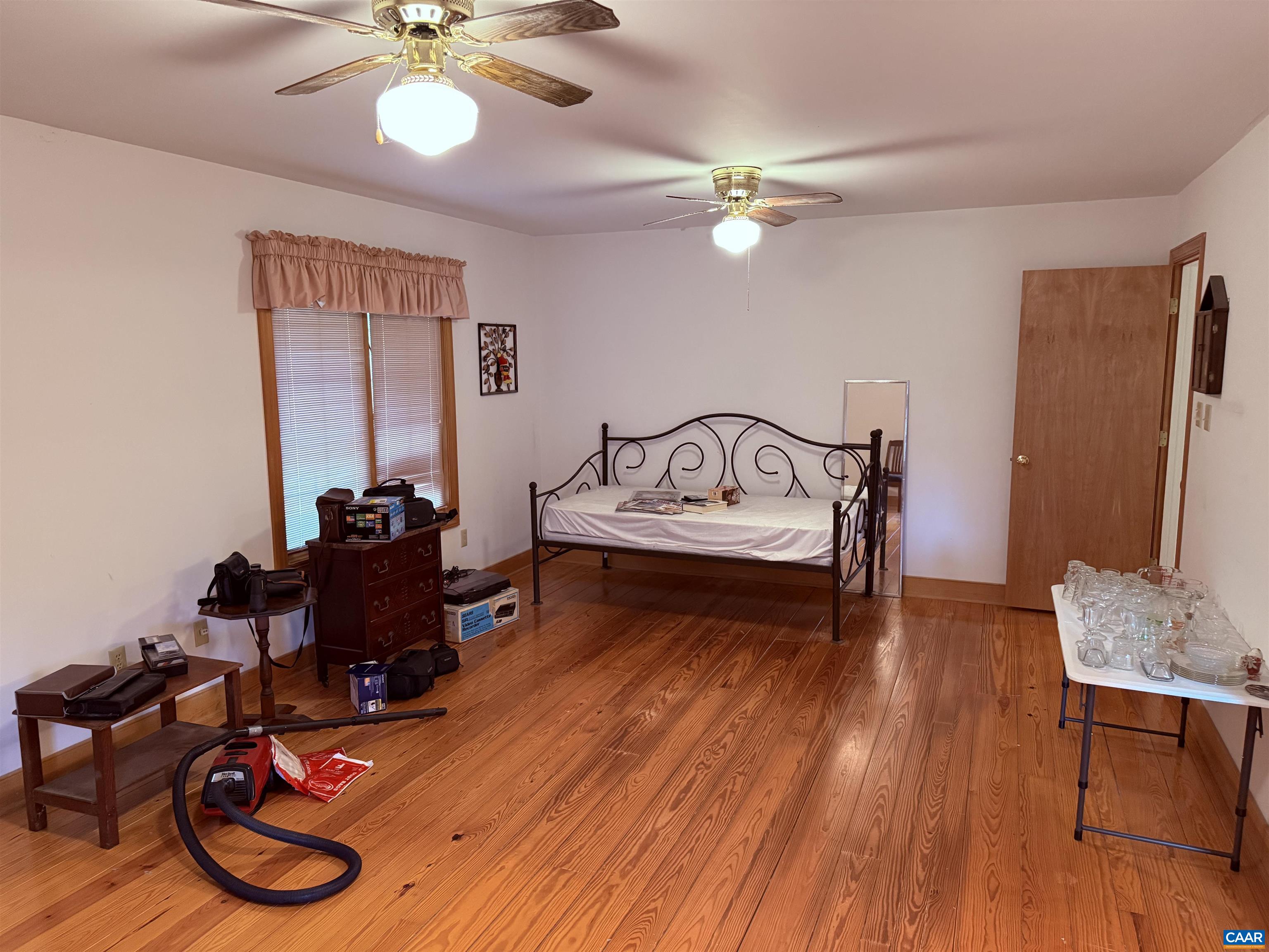 5051 Shannon Hill Road Kents Store, VA 23084 - Photo 27 of 67 a bedroom with a bed and wooden floor