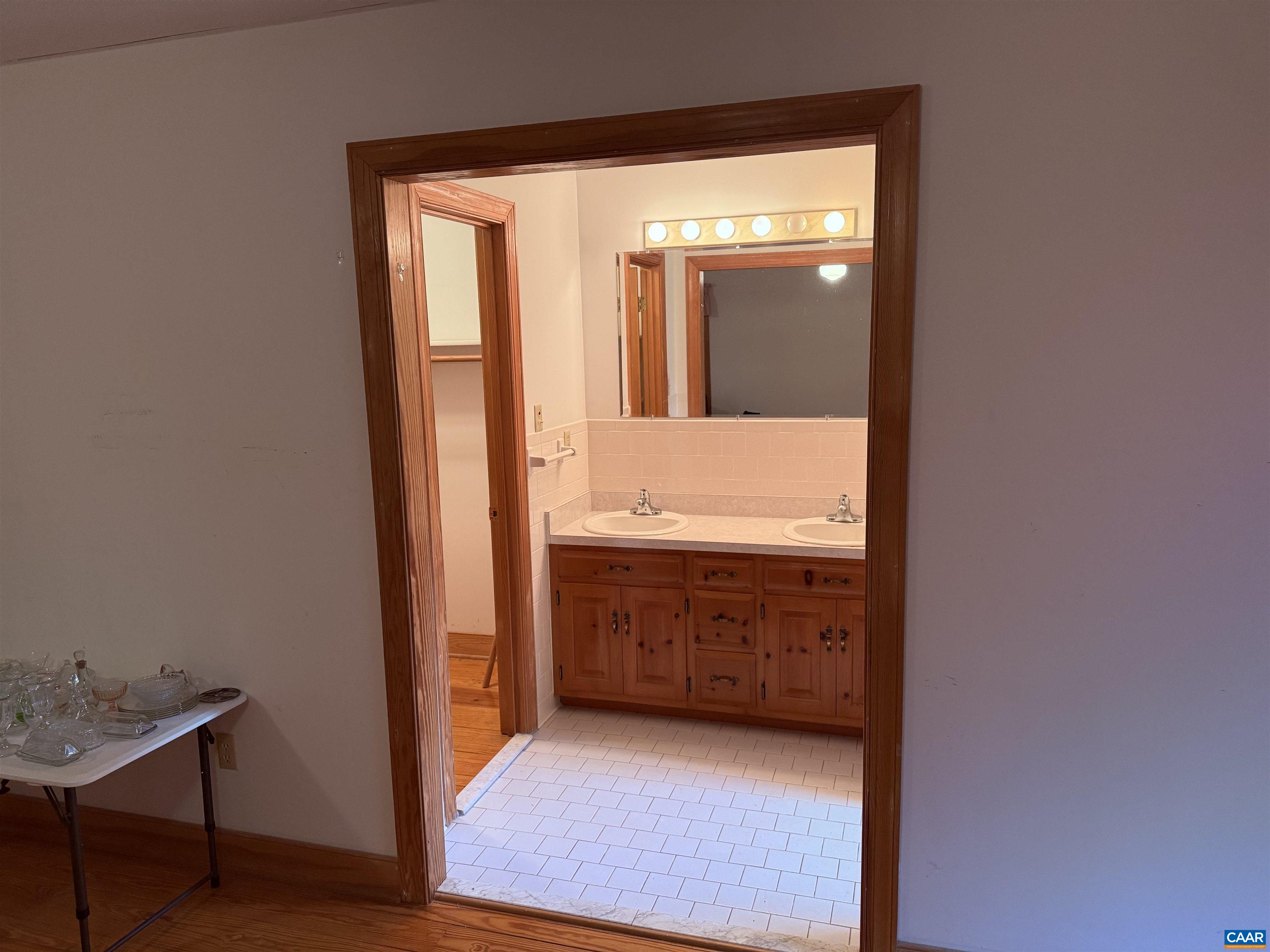 5051 Shannon Hill Road Kents Store, VA 23084 - Photo 30 of 67 a bathroom with a granite countertop sink and a mirror