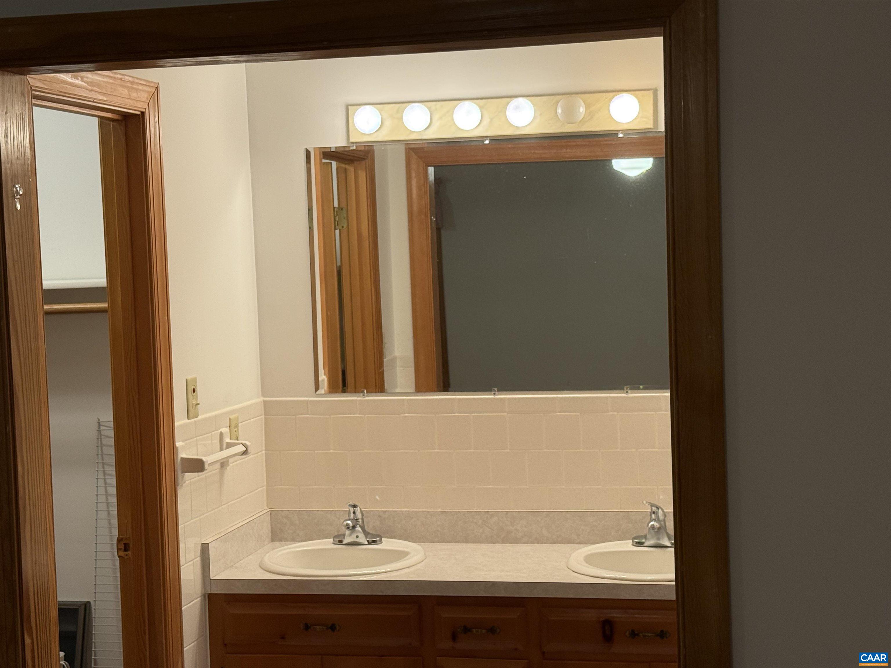 5051 Shannon Hill Road Kents Store, VA 23084 - Photo 33 of 67 a bathroom with a sink and a mirror