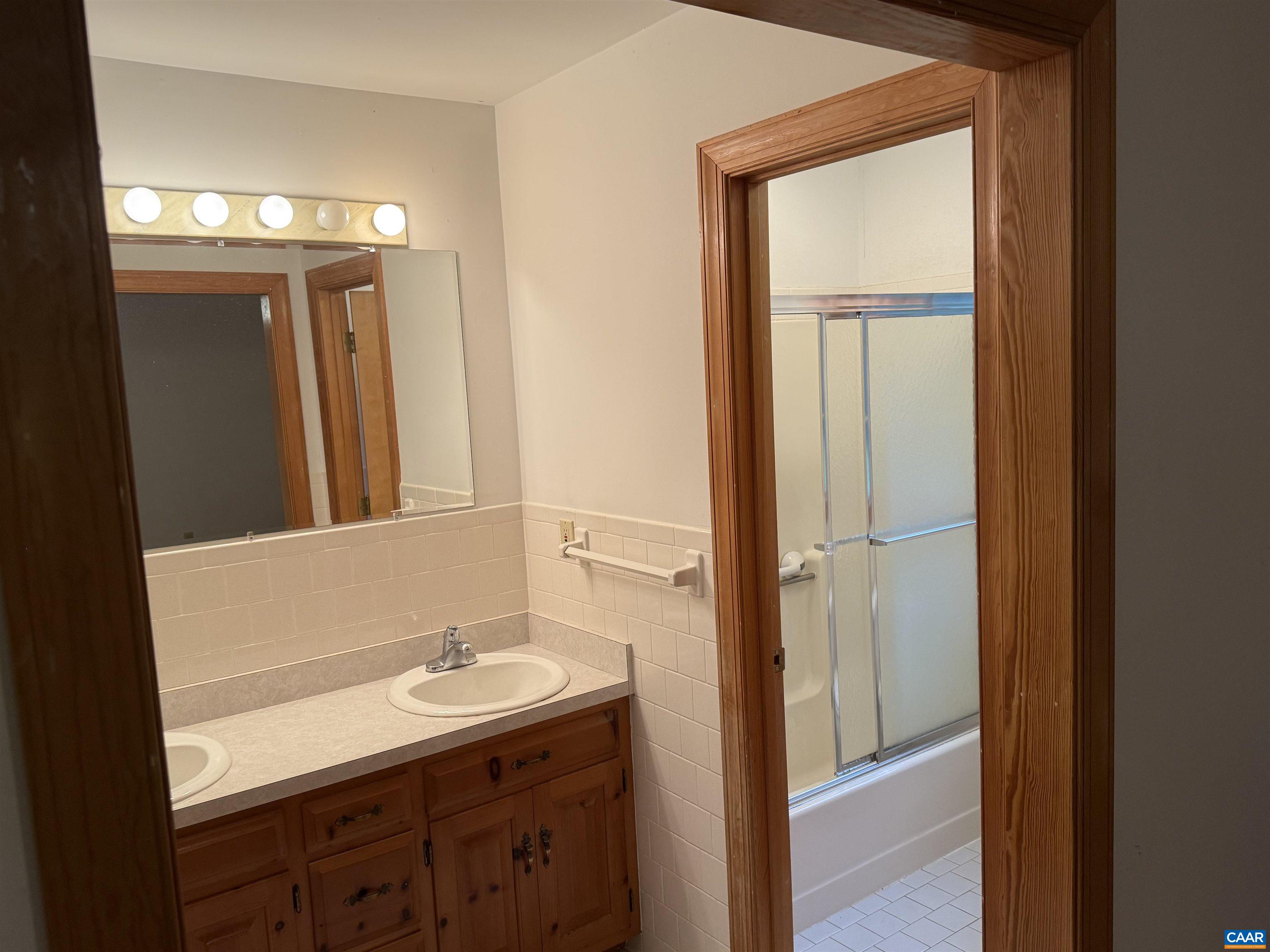 5051 Shannon Hill Road Kents Store, VA 23084 - Photo 34 of 67 a bathroom with a sink a light fixture and a mirror