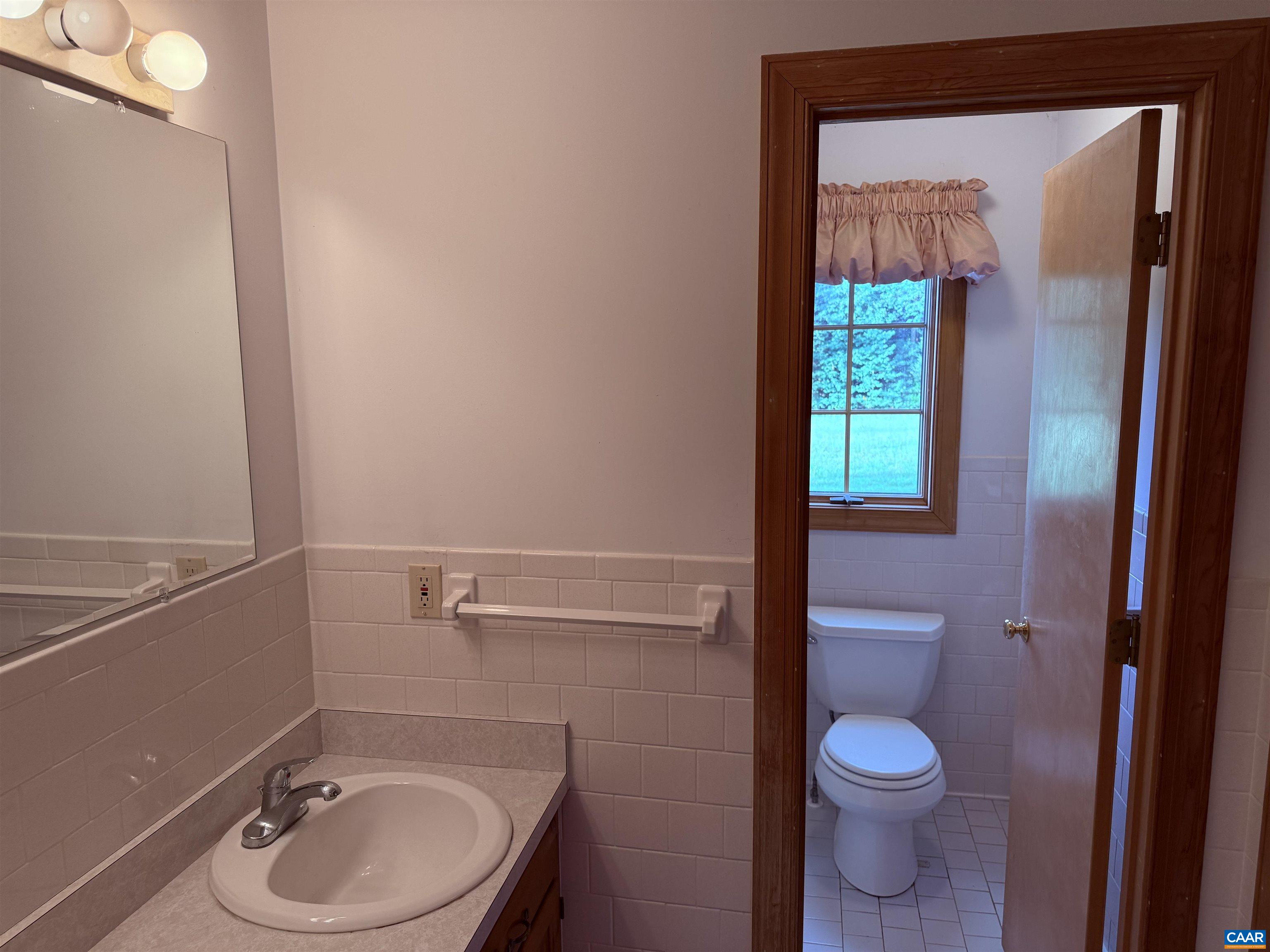 5051 Shannon Hill Road Kents Store, VA 23084 - Photo 35 of 67 a bathroom with a sink a toilet and a mirror