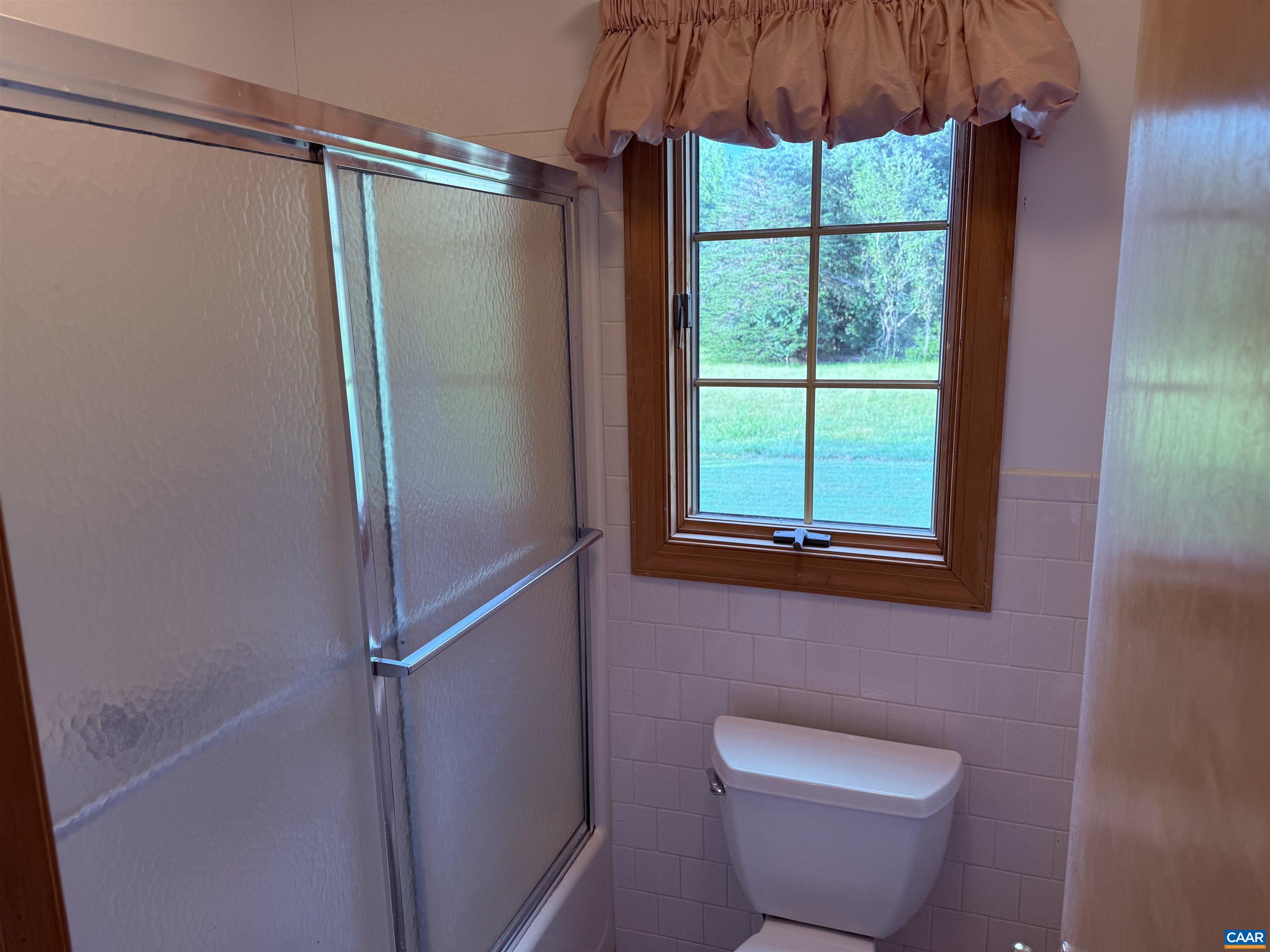 5051 Shannon Hill Road Kents Store, VA 23084 - Photo 36 of 67 a bathroom with a toilet a sink and a shower