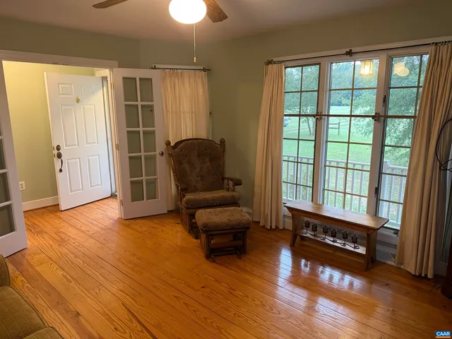 a living room with furniture a fireplace and a chandelier