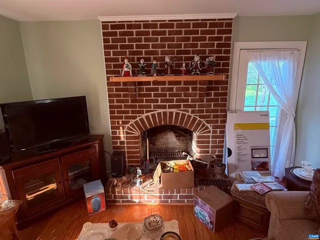 a view of a fireplace with wooden floor