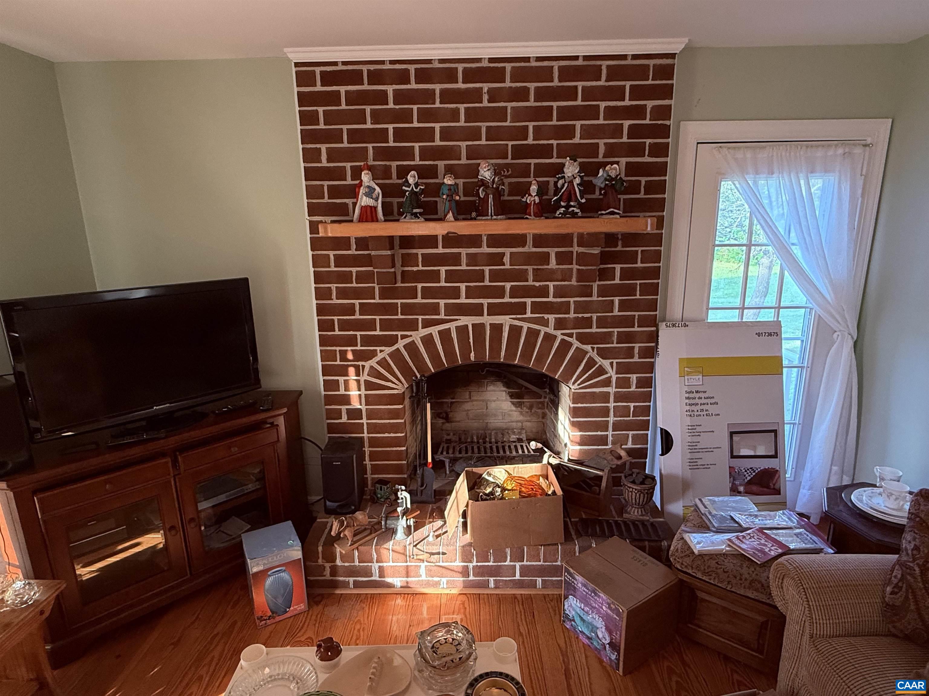 5051 Shannon Hill Road Kents Store, VA 23084 - Photo 10 of 67 a living room with fireplace furniture and a flat screen tv