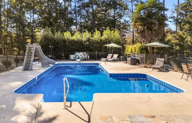 a room with furniture pool table and flat screen tv