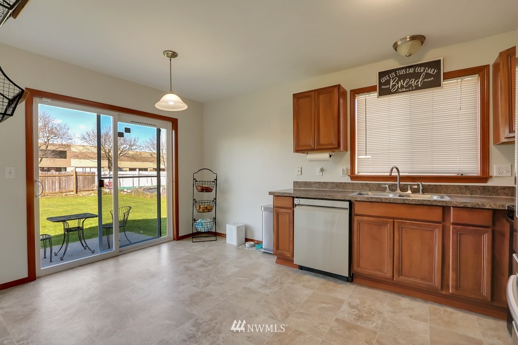13 Rips Lane Southwest Lakewood, WA 98499 - Photo 7 of 21 a open kitchen with granite countertop a sink and a stove