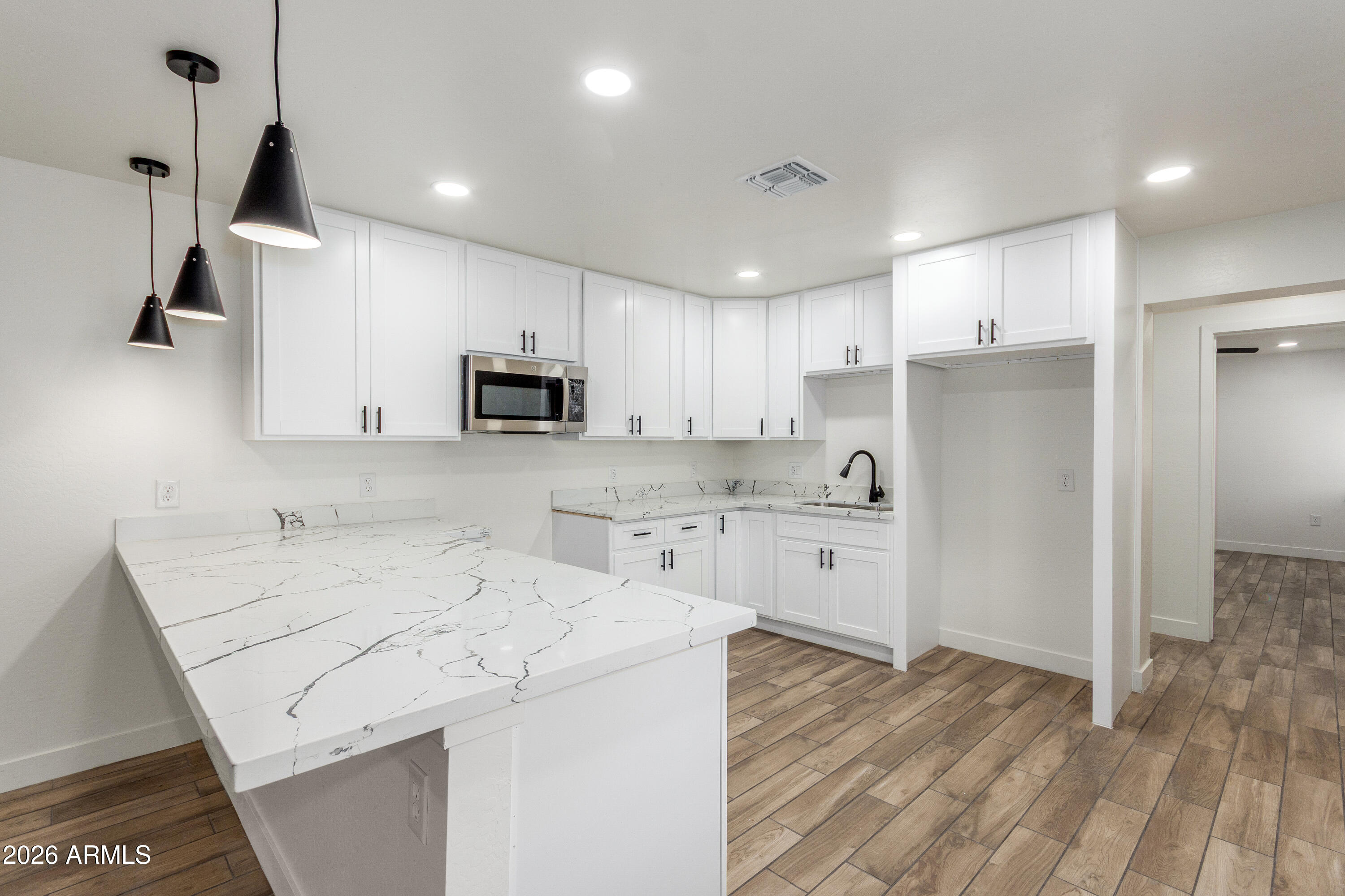 16632 North 18th Place Phoenix, AZ 85022 - Photo 15 of 28 a kitchen with a sink a stove a refrigerator and cabinets