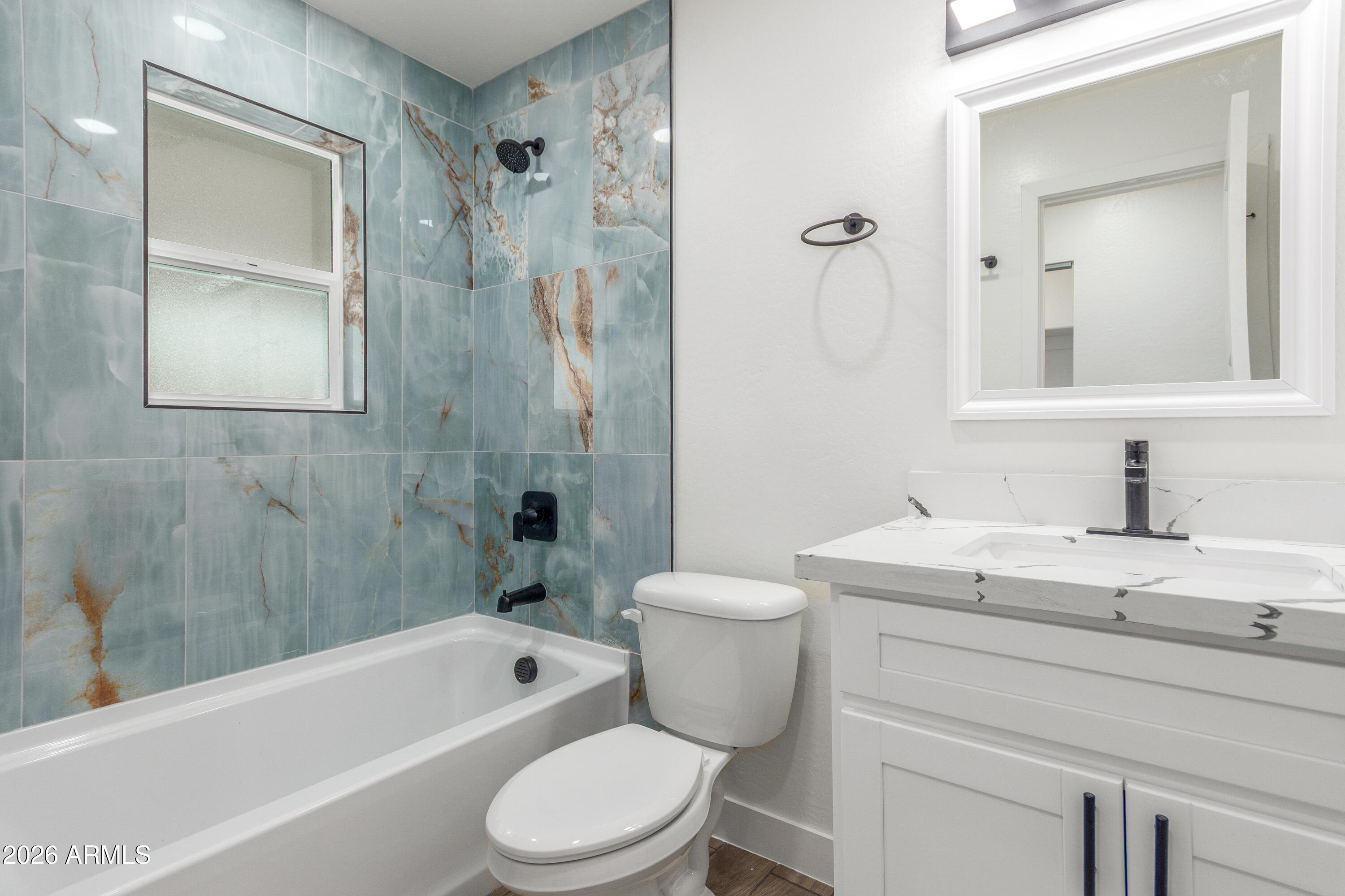 16632 North 18th Place Phoenix, AZ 85022 - Photo 19 of 28 a bathroom with a granite countertop toilet a sink and bathtub