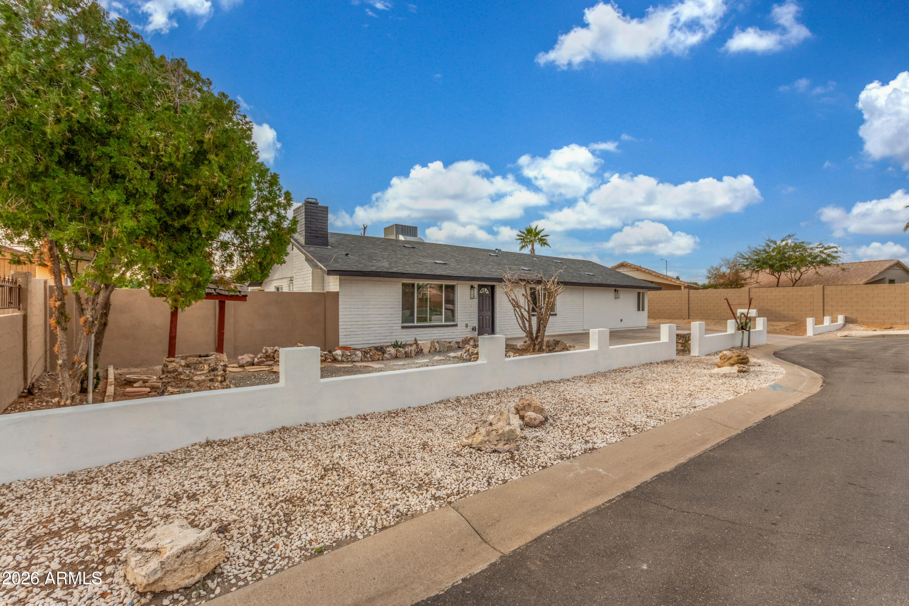 16632 North 18th Place Phoenix, AZ 85022 - Photo 3 of 28 a front view of a house with garden and patio