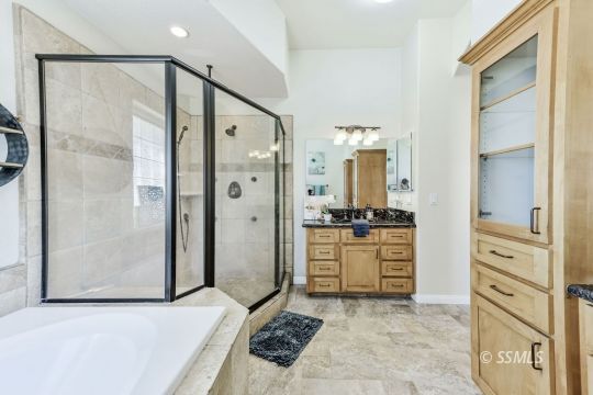 1213 Carolyn Street Ridgecrest, CA 93555 - Photo 26 of 50 a bathroom with a granite countertop sink mirror and a bathtub