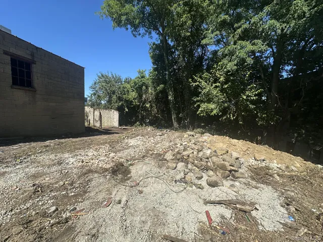 an aerial view of a house with a yard and lake view